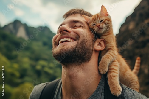 A kitten rests its head on a person’s face with a scenic mountain background, blending natural beauty with a heartwarming display of trust and bonding between human and pet.