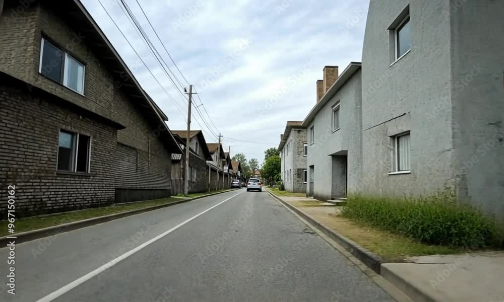 along a road with buildings on either side of the road along a road with buildings on either side of the road