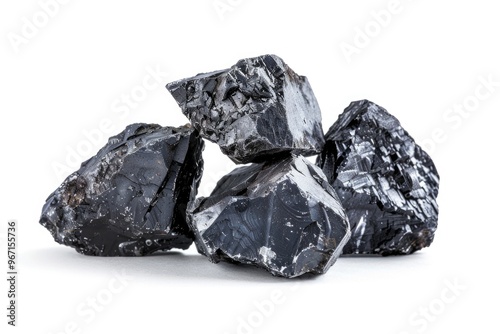 A close-up shot of a pile of black rocks on a white surface