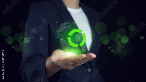 Businessman holding circular economy symbol on virtual screen. sustainable development growth business earning. Circular economy concept.