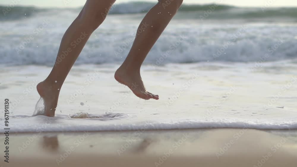 slow motion. Girl after bathing in ocean go on shore. Slim female legs and feet walking along sea water waves on sandy beach. Pretty woman walks at seaside surf. Splashes of water slow motion. Girl after bathing in ocean go on shore. Slim female legs and feet walking along sea water waves on sandy beach. Pretty woman walks at seaside surf. Splashes of water