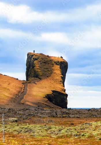 A large rock formation with a path leading up to it photo