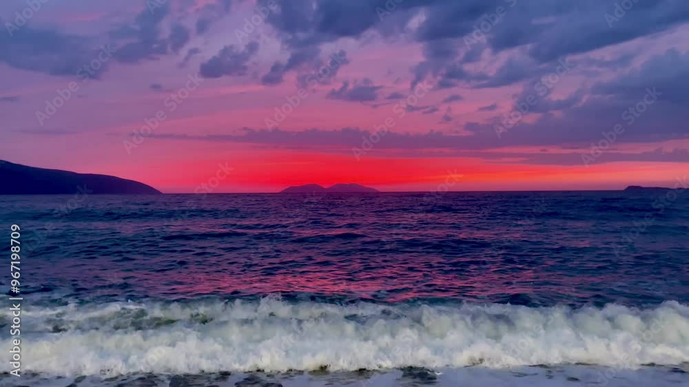 Scenic view of waves rushing at sandy beach against sky during sunset Scenic view of waves rushing at sandy beach against sky during sunset