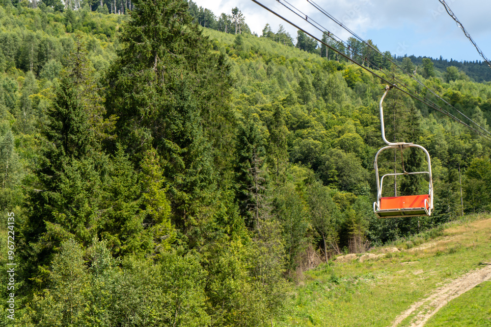 Fototapeta premium Cableway to top of Carpathian Mountain peak. Hills forest. Nature summer
