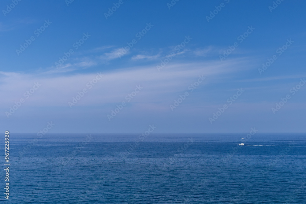 white boat sailing on the ocean, horizon and bright blue sky white boat sailing on the ocean, horizon and bright blue sky
