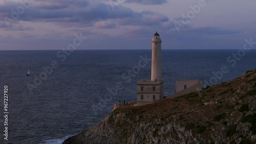 Otranto, Puglia, Italy - A Scenic View of the Faro Palascia Lighthouse Perched on the Promontory, Facing the Adriatic Sea at Sunset - Pan Down Shot photo