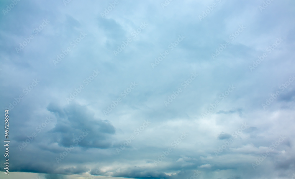 Rain clouds over a mountain range in the distance. Change of weather in the rainy season. Thunderclouds, an approaching storm. Rain clouds over a mountain range in the distance. Change of weather in the rainy season. Thunderclouds, an approaching storm.