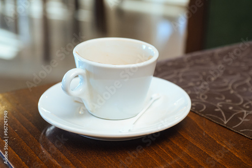 Empty coffee cup on the table in the restaurant photo