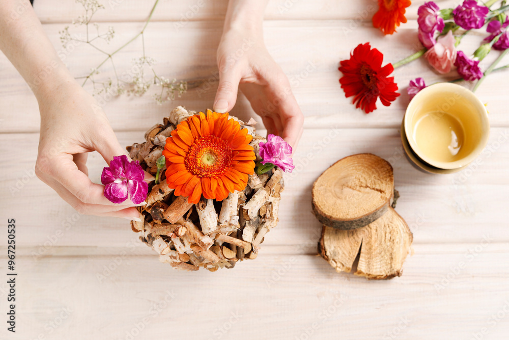 Florist at work: woman shows how to make table decoration with flowers and birch ball. Step by step, tutorial. Florist at work: woman shows how to make table decoration with flowers and birch ball. Step by step, tutorial.