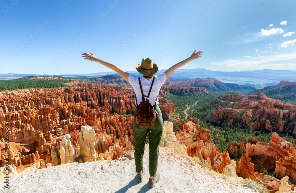 Girl on summer vacation hiking trip. Girl alone hiking on footpath in red mountains. Bryce Canyon National Park, Utah, USA Girl on summer vacation hiking trip. Girl alone hiking on footpath in red mountains. Bryce Canyon National Park, Utah, USA