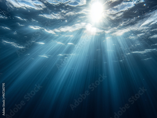 A serene underwater scene with sunlight piercing through the surface of the water, casting soft, diffused rays that illuminate the deep blue ocean below