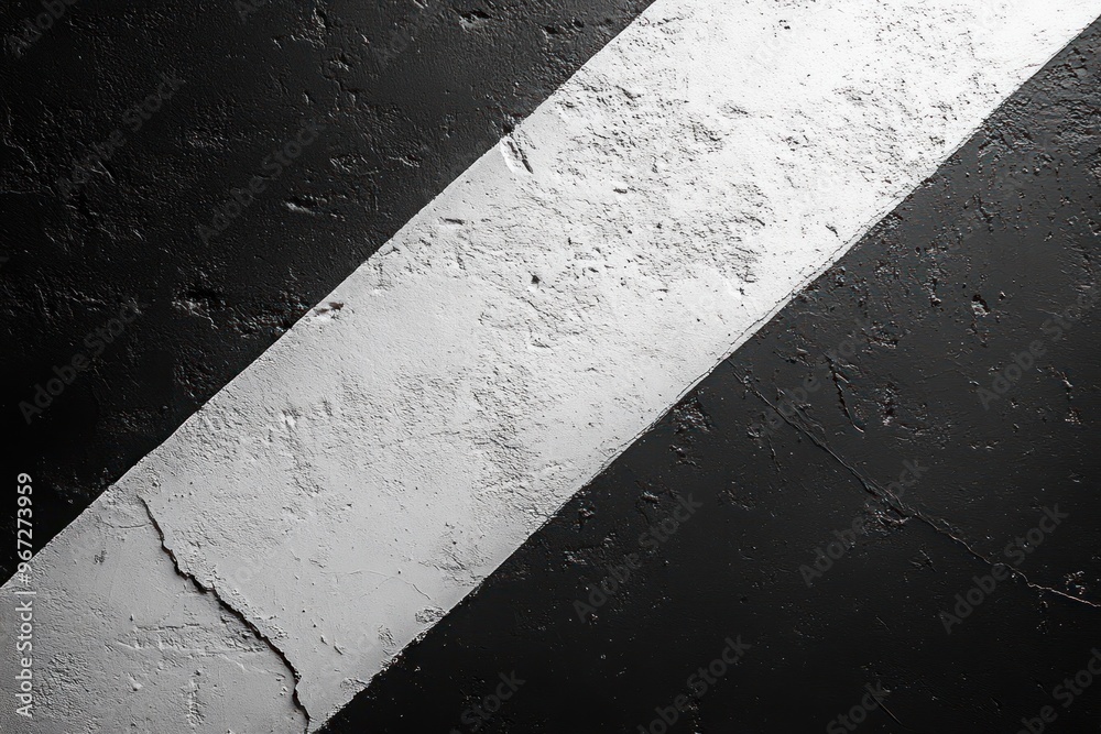Fototapeta premium A Diagonal White Stripe on a Rough Black Surface