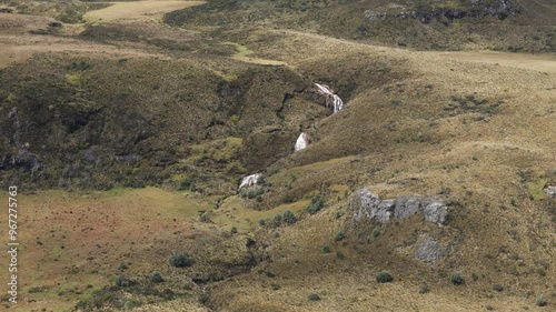 Aerial view of a waterfall in the Chimborazo mountains, Ecuador, with rugged landscape, panoramic overview