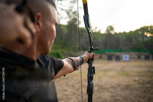A man is holding a bow and arrow and is about to shoot an arrow