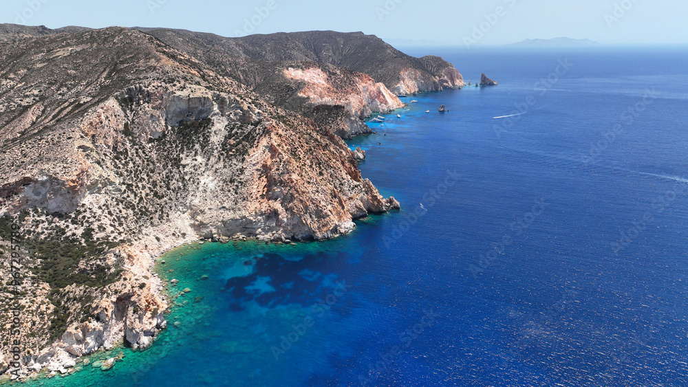 Fototapeta premium Aerial drone photo of paradise blue bay of uninhabited island of Polyaigos with turquoise crystal clear sea visited by luxury yachts and sail boats resembling a blue lagoon, Cyclades, Greece