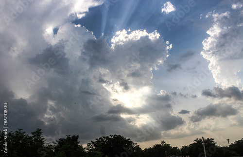 Dark clouds in the sky. Rays of light are coming out from between the clouds. 