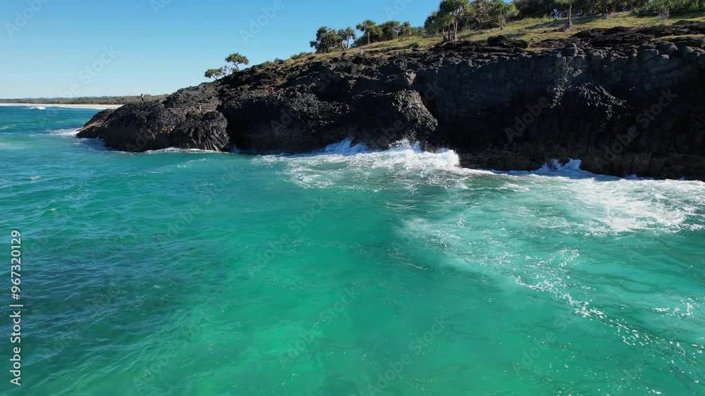 Ocean Waves Splashing On Rocky Fingal Headland With Mullet Fish Underwater In New South Wales, Australia. static shot Ocean Waves Splashing On Rocky Fingal Headland With Mullet Fish Underwater In New South Wales, Australia. static shot