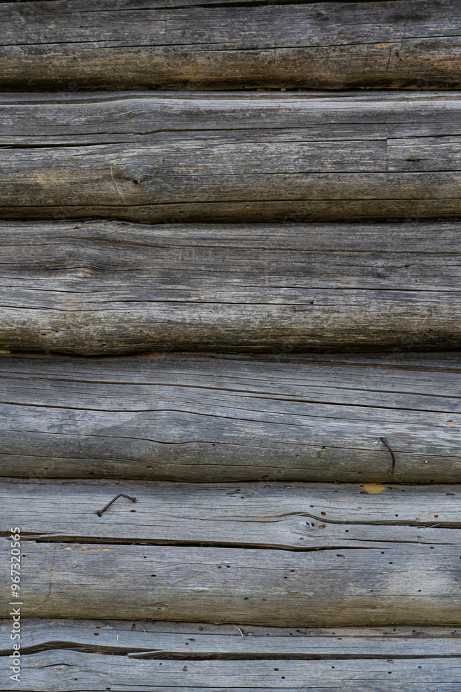 The wall of a wooden hut in the village. Logs background The wall of a wooden hut in the village. Logs background