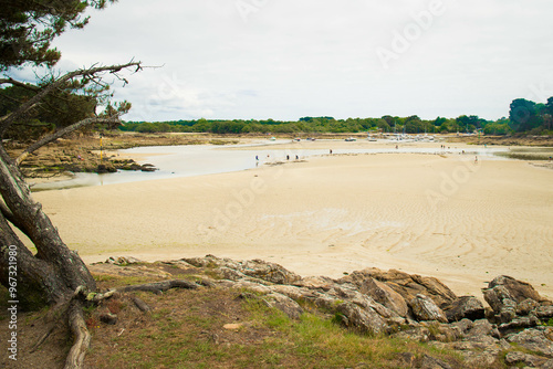 People, not recognizable, enjoying  Plage de Minaouet beach during low tide. Finistere, Brittany, France. photo