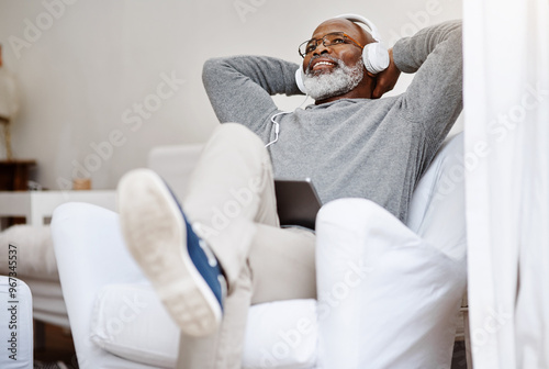 Wall Mural Senior black man, relax and streaming music, podcast or jazz on radio in living room