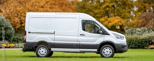 A spacious and modern white delivery van parked in a lush outdoor setting, perfect for transport and logistics imagery.