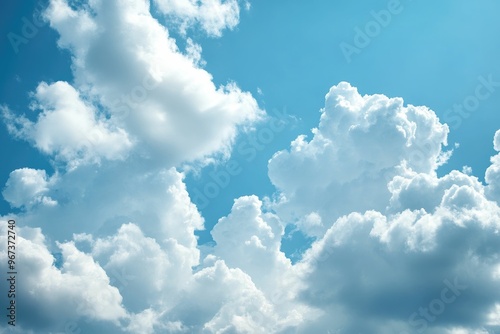 Fluffy white clouds against a bright blue sky.