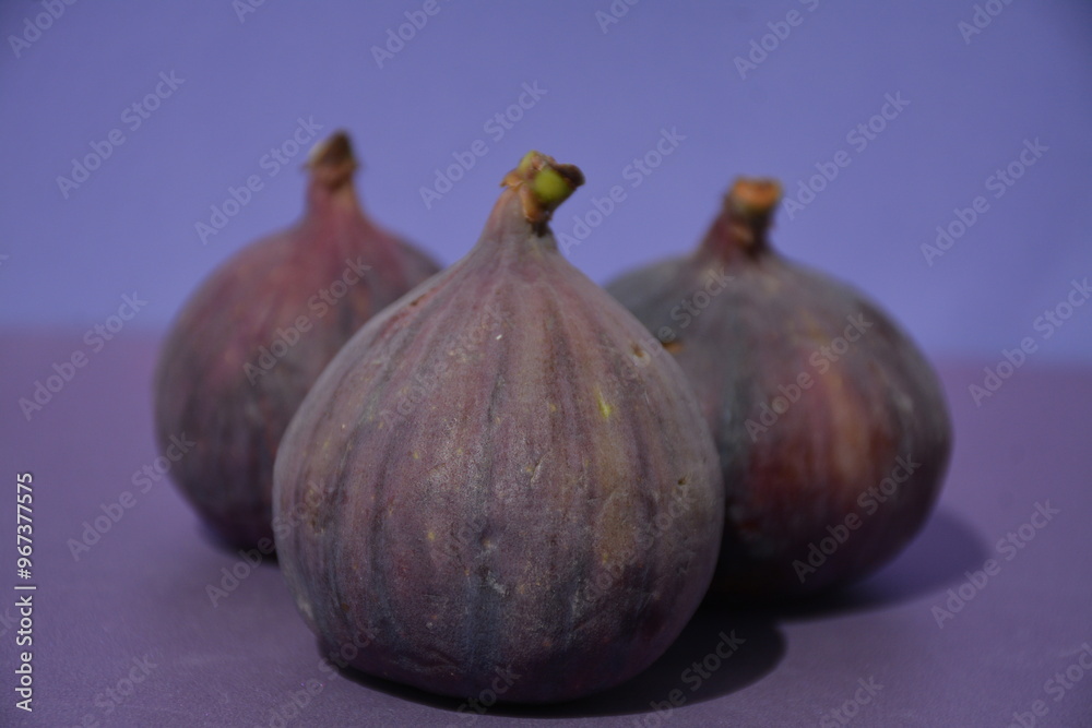 Three purple figs on a purple background Three purple figs on a purple background