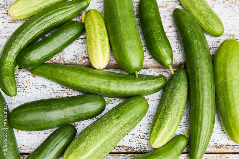 Freshly harvested cucumbers on rustic wooden background, showcasing gardening produce