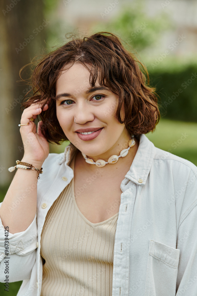 A cheerful young woman revels in the warmth of summer, basking in the lush greenery of the park. A cheerful young woman revels in the warmth of summer, basking in the lush greenery of the park.