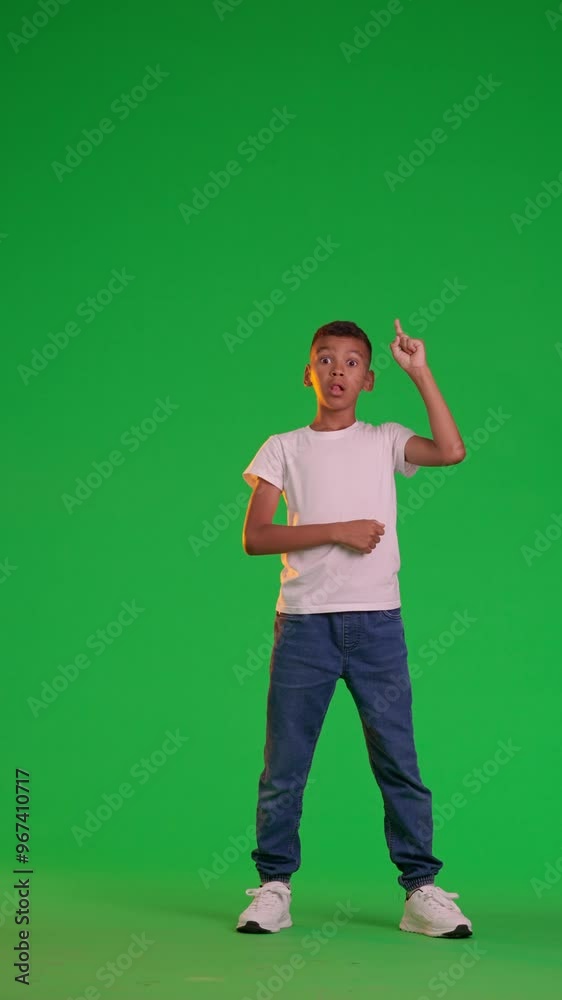 A schoolboy stands and thinks on a green screen A schoolboy stands and thinks on a green screen