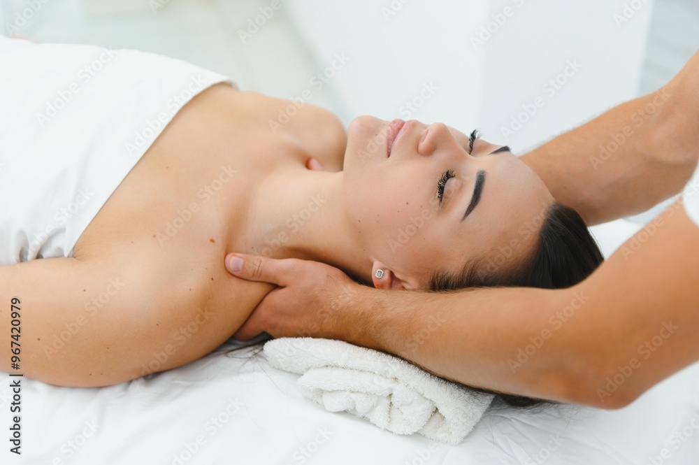Beautiful woman enjoying face lifting massage in spa salon Beautiful woman enjoying face lifting massage in spa salon