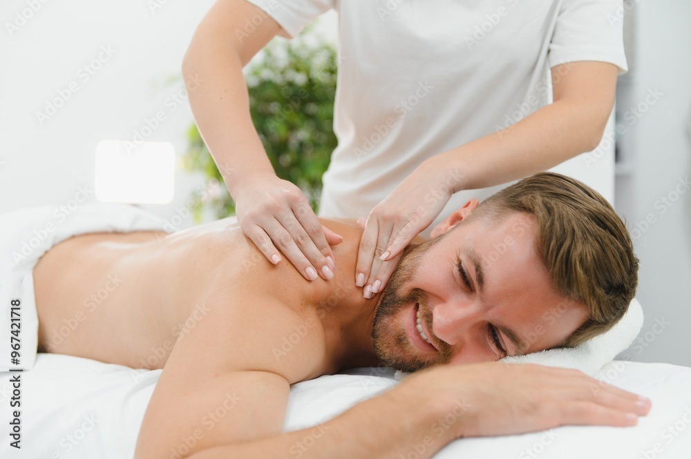 Young man is enjoying massage on spa treatment Young man is enjoying massage on spa treatment