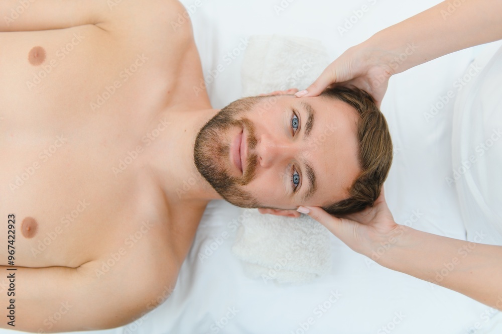 Spa therapist making relaxing massage for handsome man. Male cosmetology concept Spa therapist making relaxing massage for handsome man. Male cosmetology concept