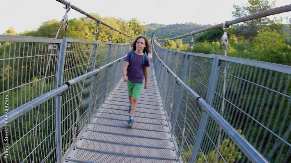 boy with a backpack. hiking with children. a boy with a backpack crosses the canyon on a rope bridge. I travel with children. boy with a backpack. hiking with children. a boy with a backpack crosses the canyon on a rope bridge. I travel with children.