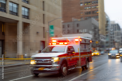 A blurred ambulance races through the bustling streets of New York City, a beacon of hope and help in times of need.