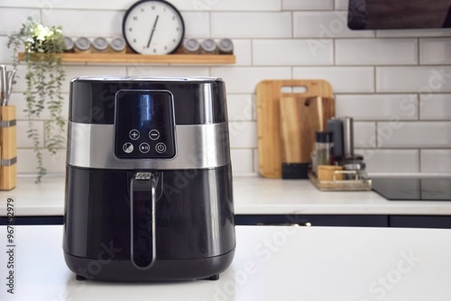 Black air fryer in the kitchen.  Healthy food preparation