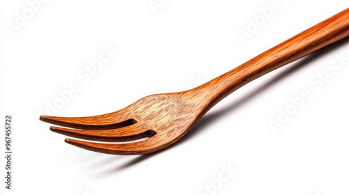 A close-up of a beautifully crafted wooden fork, highlighting its elegant design and natural wood grain against a white background. photo