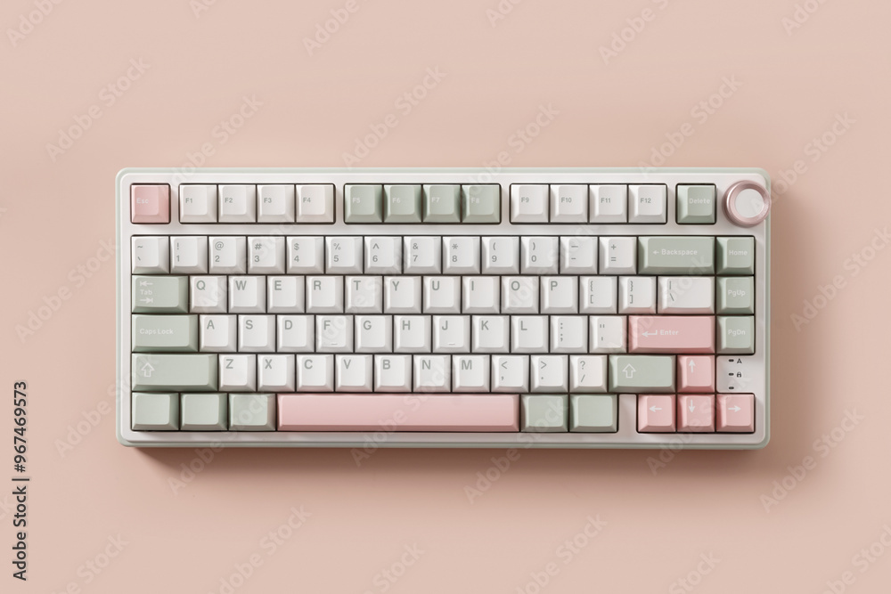 Modern mechanical keyboard on pink background. Minimal style and design keyboard. Custom build keyboard. Colorful key pastel creamy pink and green cap. Top view.