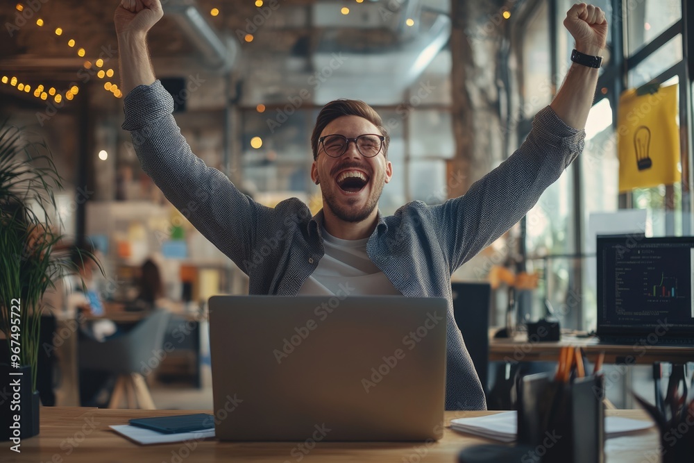 Fototapeta premium a young businessman celebrating success in the office with a laptop, happy male feeling overjoyed and excited about his successful business venture,generative ai