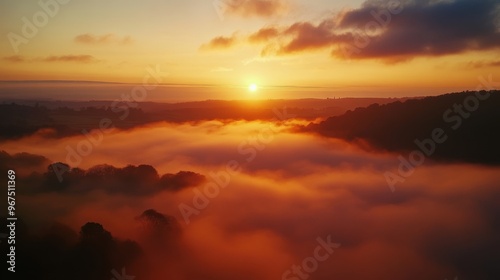 A beautiful sunrise over a sea of mist in the countryside, with the fog slowly dissipating