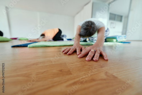 Senior Women Embrace Wellness: Yoga and Stretching in a Sunlit Space