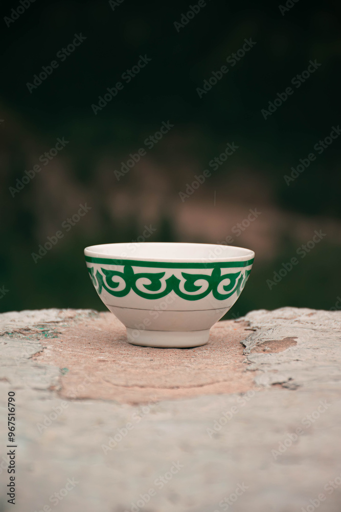 Kazakh bowl piala with national ornament. Autumn mountains on the background. Pefrect photo for Nauryz greetings. Kazakhstan, Almaty, Medeo Kazakh bowl piala with national ornament. Autumn mountains on the background. Pefrect photo for Nauryz greetings. Kazakhstan, Almaty, Medeo