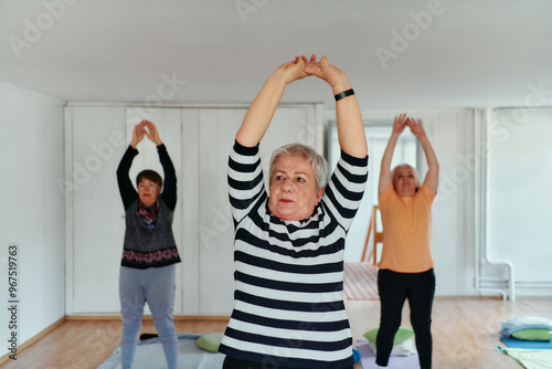 Senior Women Embrace Wellness: Yoga and Stretching in a Sunlit Space