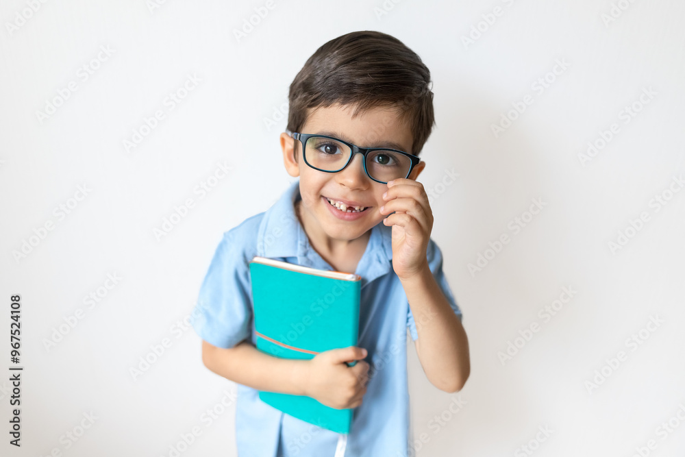Portrait of cute boy in glasses with book. Remote learning. Distance education. Boy is reading. Education concept Portrait of cute boy in glasses with book. Remote learning. Distance education. Boy is reading. Education concept