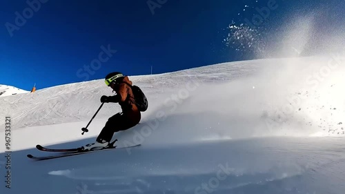 Skier Gliding Down Snowy Slope on a Clear Day