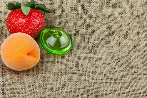 Apricots and strawberries on a color background for the baby nibbler photo