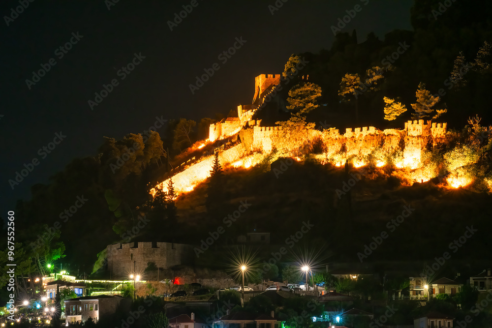 The castle of Nafpaktos ato night with the city lights.