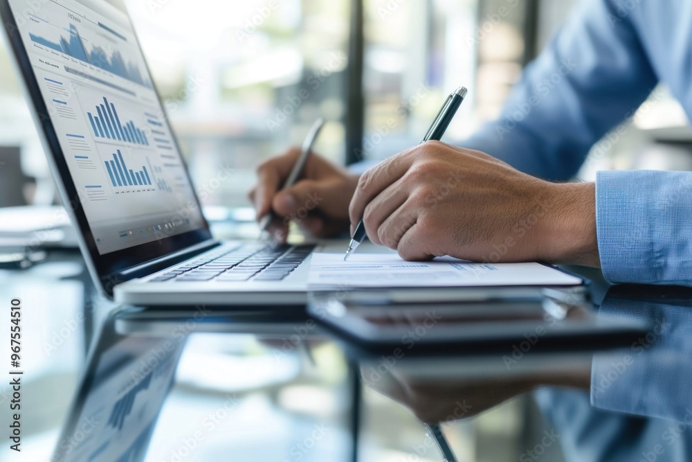 Businessman Analyzing Data and Writing Notes Businessman Analyzing Data and Writing Notes