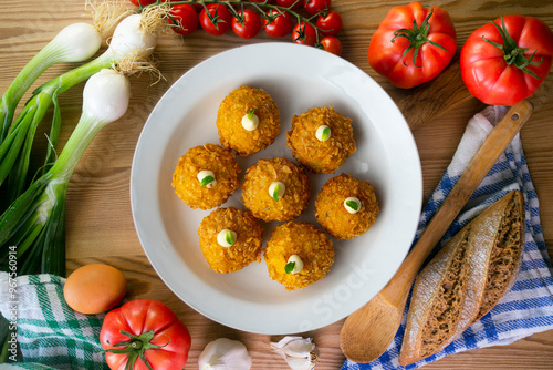 Spanish Tapa croquettes made with bechamel sauce and stuffed fish and mayonnaise. Top view table. photo