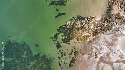 Aerial view of serene Longniddry Bents beach with beautiful green water and rocky coastline, East Lothian, United Kingdom. photo